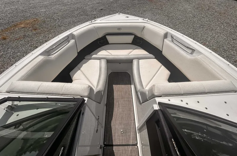 Slide: The Image of 2018 Cobalt CS23 boat interior with cushioned seating and open deck. - 11