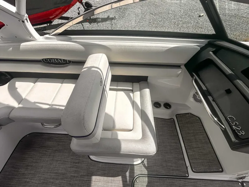 Slide: The Image of 2018 Cobalt CS23 boat interior with white seating and sleek design. - 13