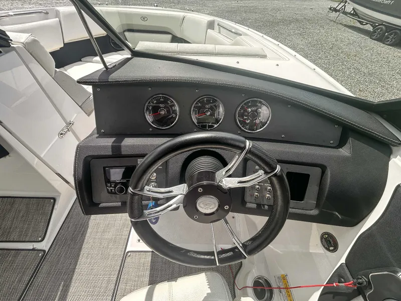 Slide: The Image of 2018 Cobalt CS23 boat dashboard with steering wheel and gauges. - 14