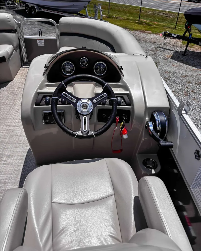 Slide: The Image of 2018 South Bay 200 Series S222RS 25 boat helm with steering wheel and controls. - 16