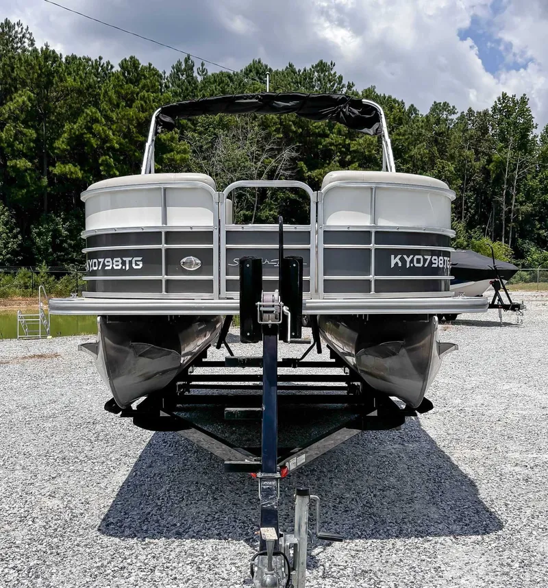 Slide: The Image of 2018 South Bay 200 Series S222RS pontoon boat on trailer, parked outdoors. - 3