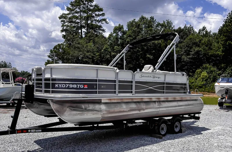 Slide: The Image of 2018 South Bay 200 Series S222RS 25 pontoon boat on trailer, parked outdoors. - 4