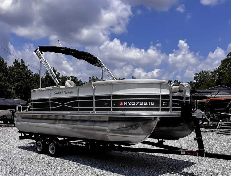 Slide: The Image of 2018 South Bay 200 Series S222RS 25 pontoon boat on trailer under blue sky. - 5