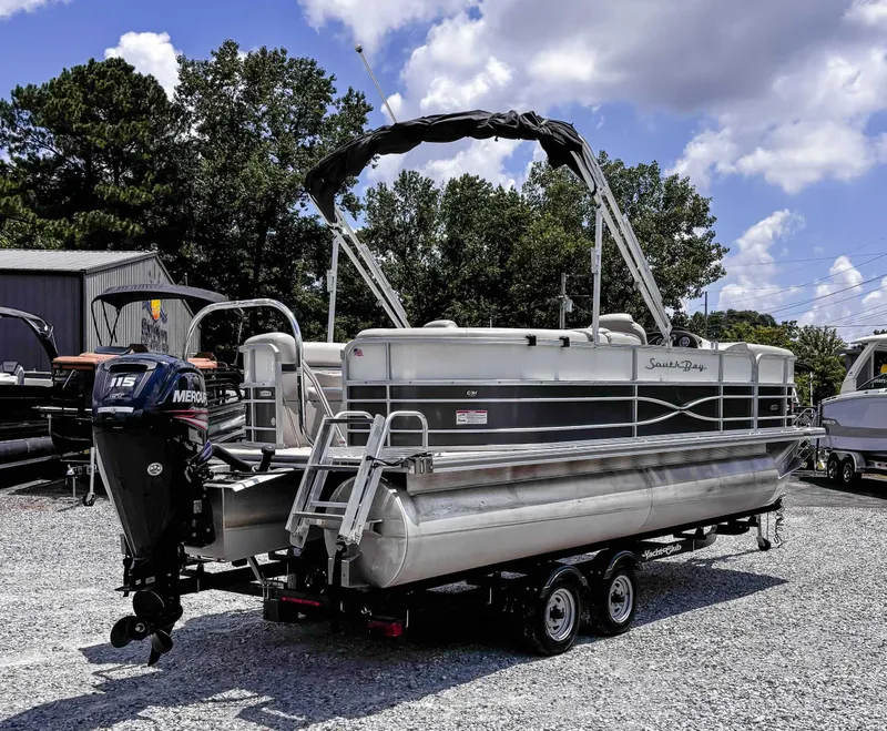 Slide: The Image of 2018 South Bay 200 Series S222RS pontoon boat on trailer, parked outdoors. - 7