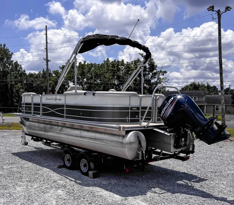 Slide: The Image of 2018 South Bay 200 Series S222RS 25 pontoon boat on trailer, outdoors. - 8