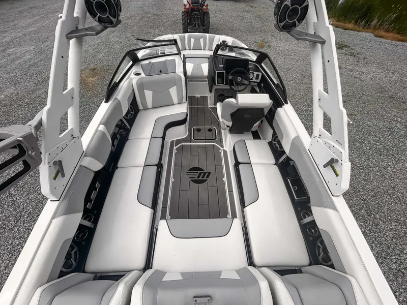 Slide: The Image of 2020 Malibu 23 MXZ boat interior with sleek seating and modern dashboard design. - 10