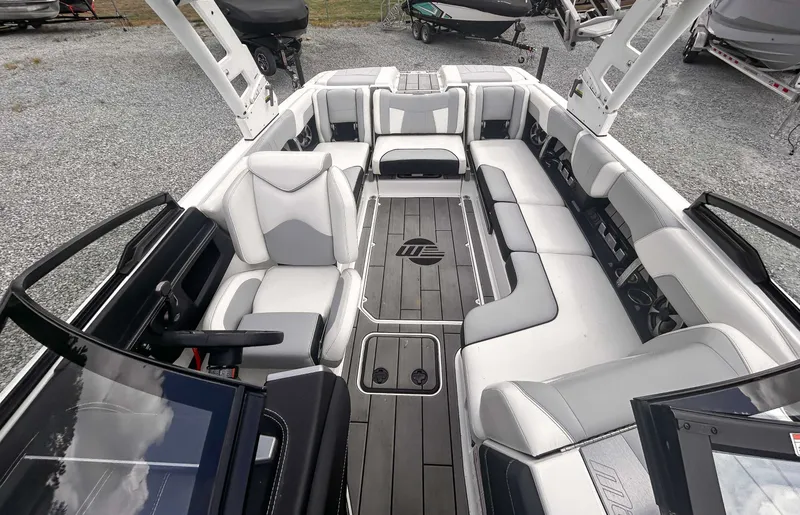 Slide: The Image of 2020 Malibu 23 MXZ boat interior with luxurious seating and sleek design. - 12