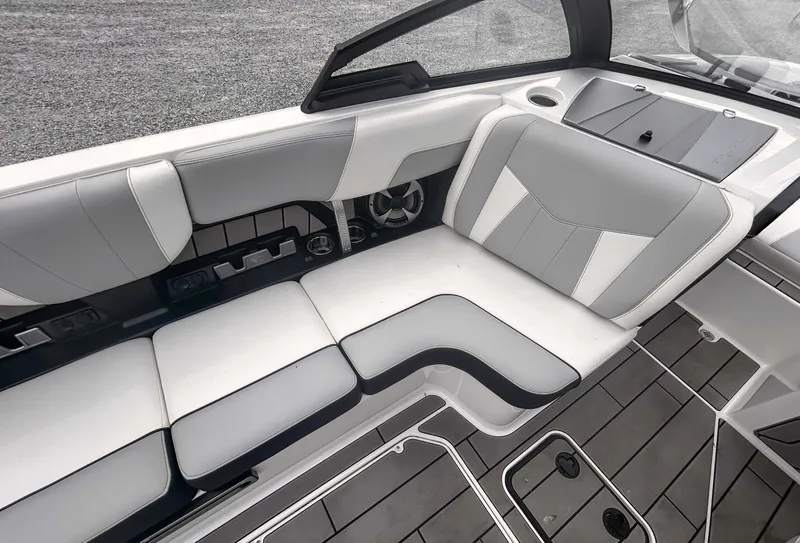 Slide: The Image of 2020 Malibu 23 MXZ boat interior with gray and white seating, modern design. - 13