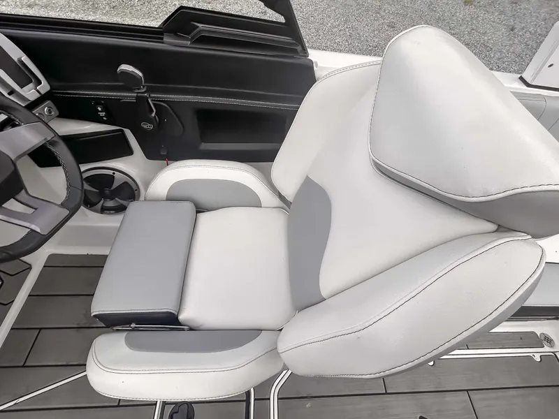 Slide: The Image of 2020 Malibu 23 MXZ boat interior with sleek, modern seating and steering wheel. - 14