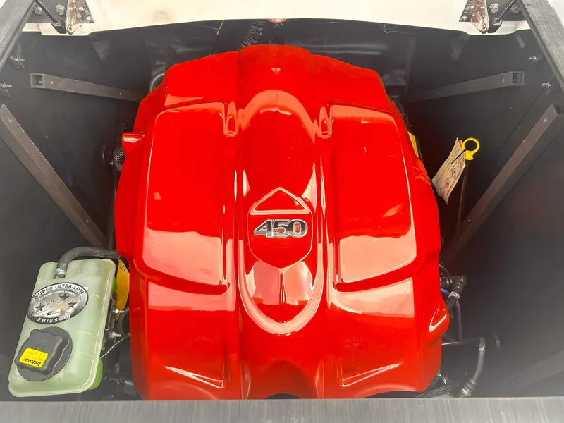 Slide: The Image of Red engine of a 2020 Malibu 23 MXZ boat, featuring a 450 horsepower cover. - 19