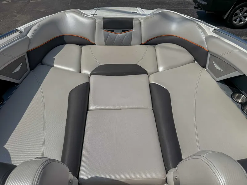 Slide: The Image of 2012 MasterCraft X55 boat interior with cushioned seating and sleek design. - 12