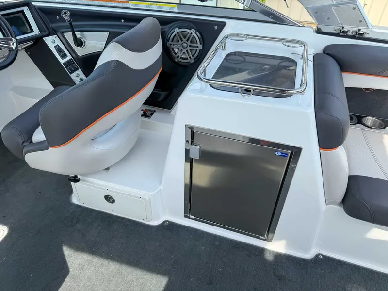 Slide: The Image of 2012 MasterCraft X55 boat interior with seating, control panel, and storage compartment. - 18