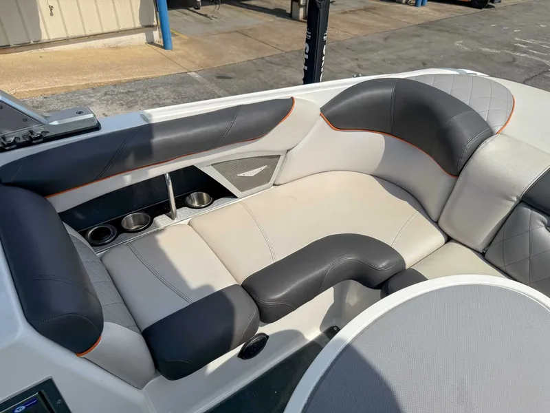 Slide: The Image of 2012 MasterCraft X55 boat interior with cushioned seating and cup holders. - 19