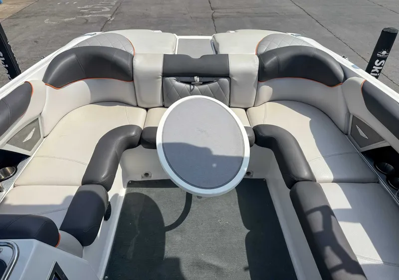 Slide: The Image of 2012 MasterCraft X55 boat interior with cushioned seating and round table. - 20