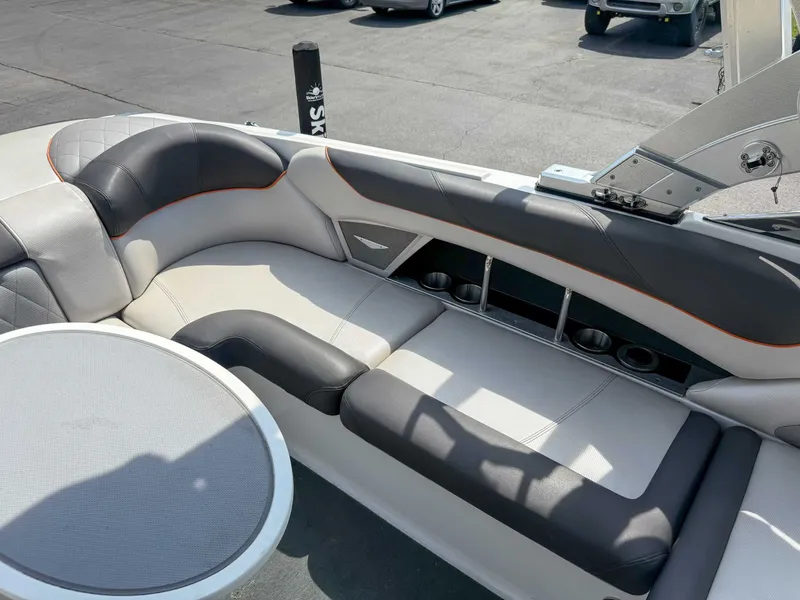 Slide: The Image of 2012 MasterCraft X55 boat interior with cushioned seating and cup holders. - 21