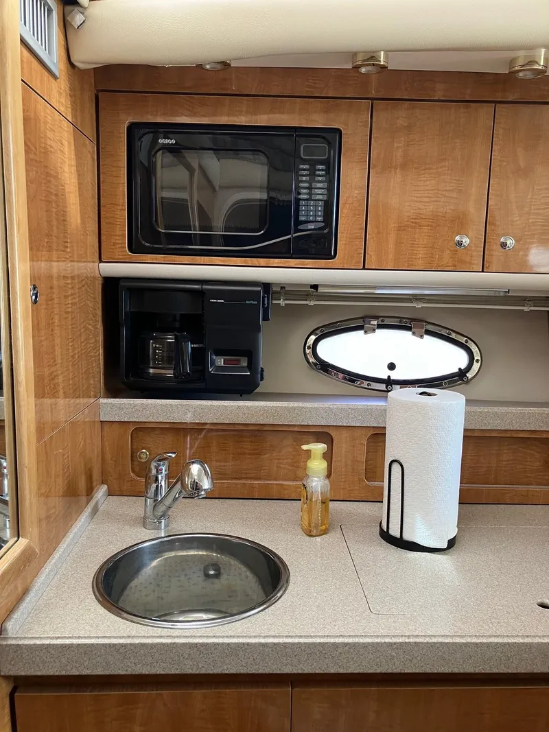 Slide: The Image of 2002 Regal Commodore 3880 yacht kitchen with microwave, coffee maker, and sink. - 10