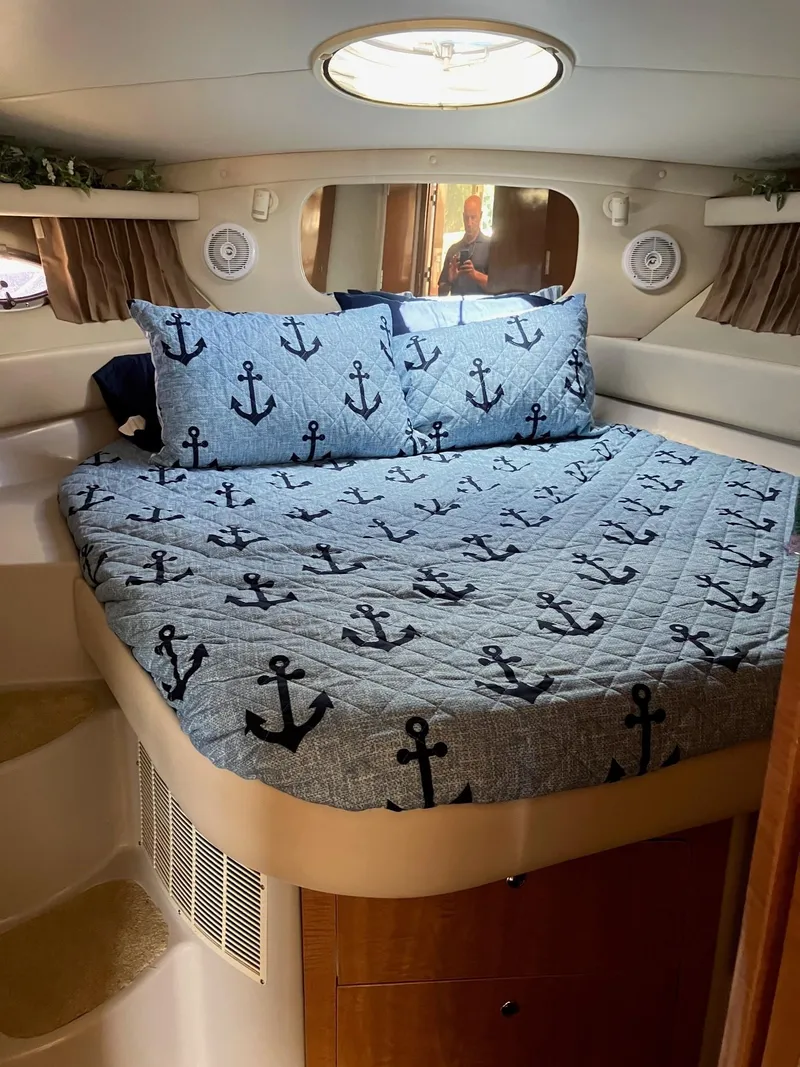 Slide: The Image of 2002 Regal Commodore 3880 cabin with anchor-themed bedding and circular skylight. - 12