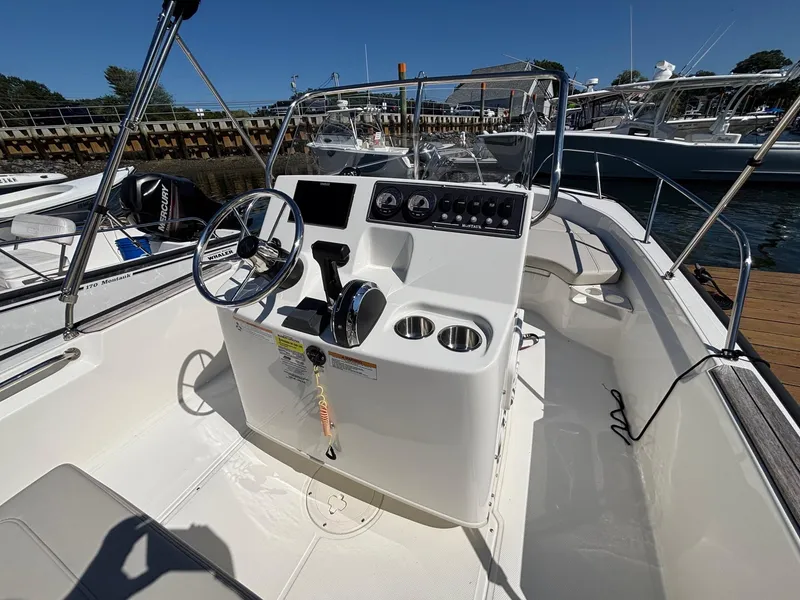 Slide: The Image of 2023 Boston Whaler 190 Montauk boat interior with steering console and seating. - 12
