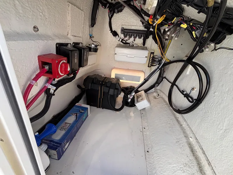Slide: The Image of Interior view of 2023 Boston Whaler 190 Montauk boat's electrical and storage compartment. - 16