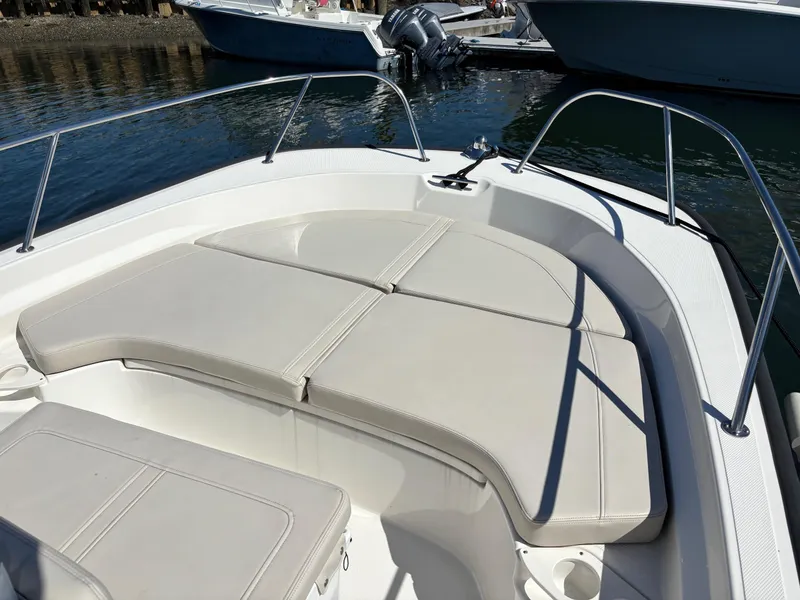 Slide: The Image of 2023 Boston Whaler 190 Montauk boat interior with cushioned seating and railing. - 5