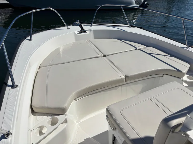Slide: The Image of 2023 Boston Whaler 190 Montauk boat interior with cushioned seating and cup holders. - 6