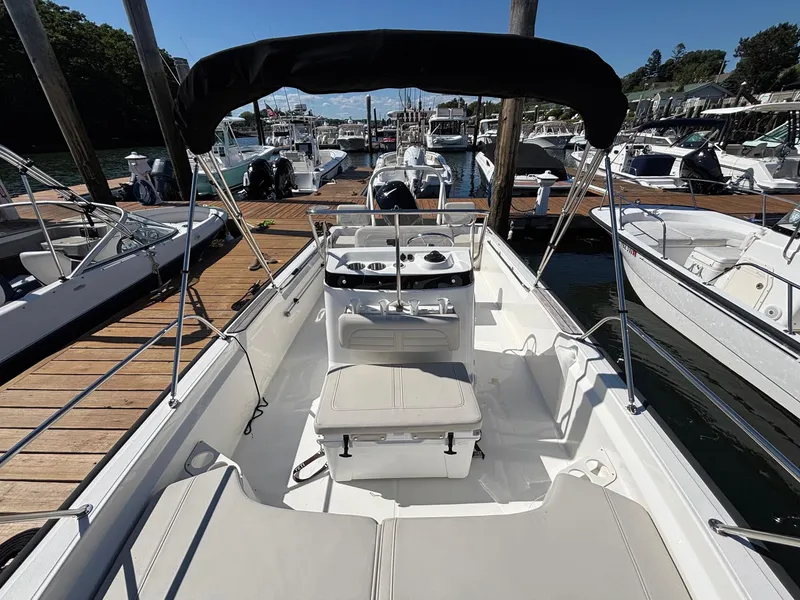 Slide: The Image of 2023 Boston Whaler 190 Montauk boat docked, featuring spacious seating and a sleek design. - 9