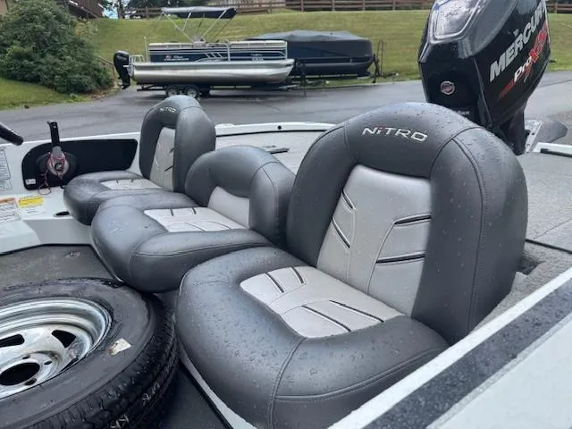 Slide: The Image of 2016 Nitro Z18 boat seats with gray upholstery, parked with a Mercury engine visible. - 10