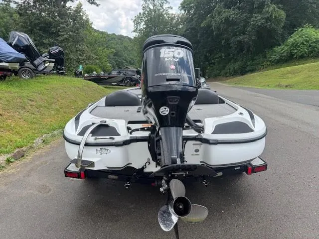 Slide: The Image of 2016 Nitro Z18 boat with 150 Pro motor on a road near greenery. - 12