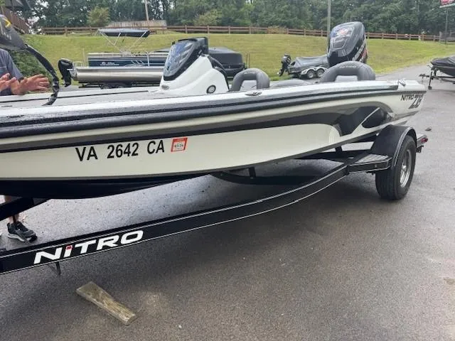 Slide: The Image of 2016 Nitro Z18 boat on trailer, parked outdoors, with visible registration number. - 8