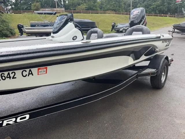 Slide: The Image of 2016 Nitro Z18 boat on trailer, parked outdoors, showcasing sleek design and modern features. - 9