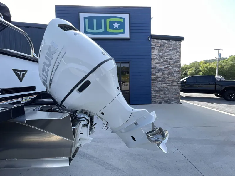 Slide: The Image of 2024 Tahoe Pontoon 23 Cascade with Suzuki outboard motor, displayed outside dealership. - 14