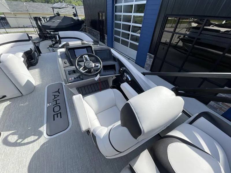 Slide: The Image of 2024 Tahoe Pontoon 23 Cascade Versatile Rear Lounger interior with steering console and seating. - 18