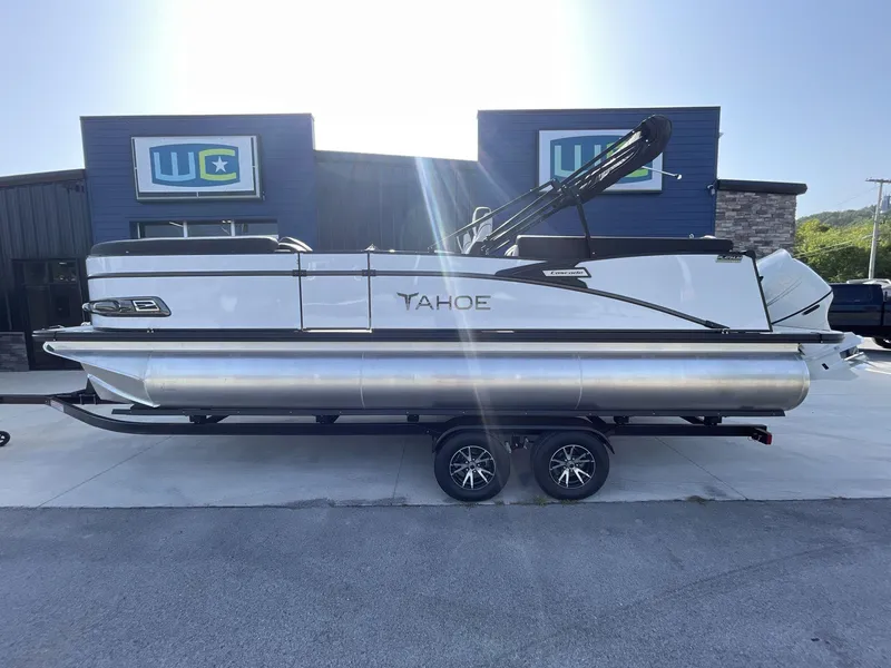 Slide: The Image of 2024 Tahoe Pontoon 23 Cascade Versatile Rear Lounger on trailer, parked outside dealership. - 2