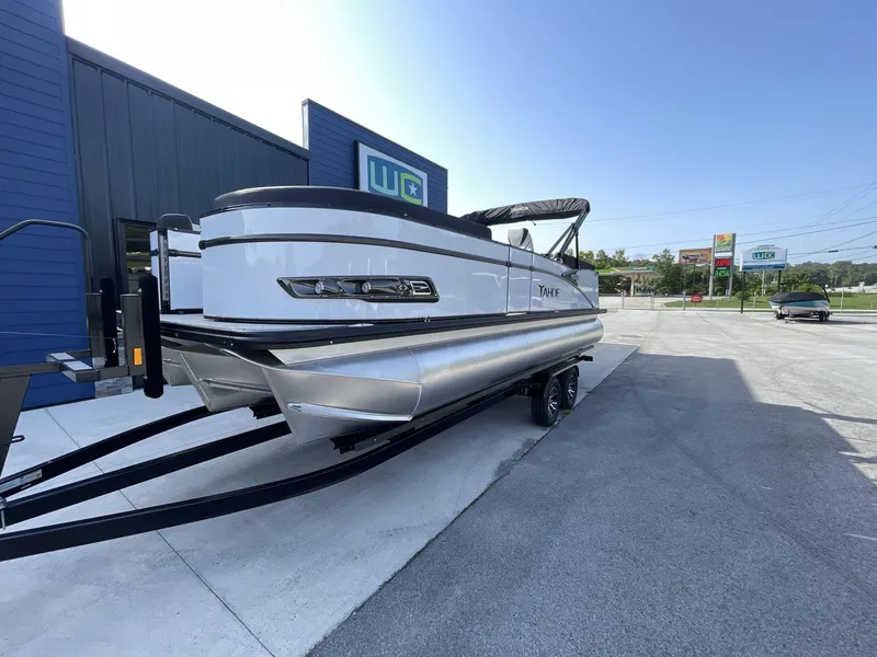 Slide: The Image of 2024 Tahoe Pontoon 23 Cascade Versatile Rear Lounger on trailer, parked outside dealership. - 4
