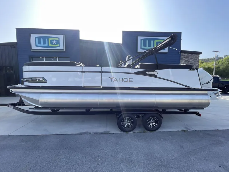Slide: The Image of 2024 Tahoe Pontoon 23 Cascade Versatile Rear Lounger, sleek design, parked outside dealership. - 5