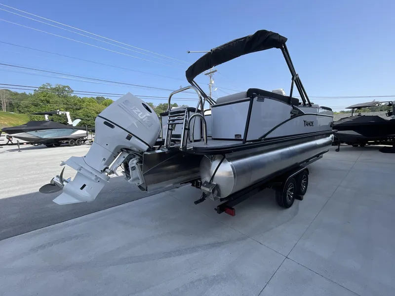 Slide: The Image of 2024 Tahoe Pontoon 23 Cascade Versatile Rear Lounger with Suzuki outboard motor, parked outdoors. - 9
