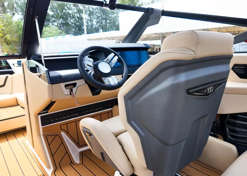 Slide: The Image of 2025 Nautique G23 boat interior with modern steering and luxurious seating. - 11