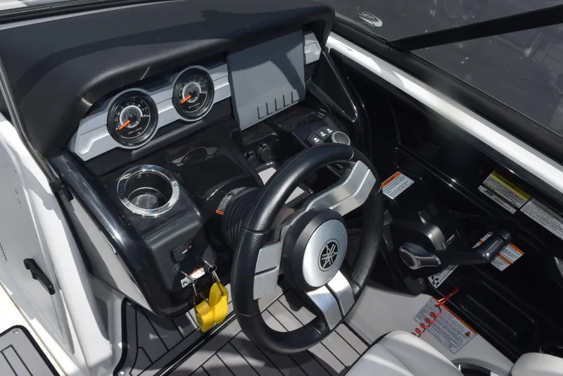 Slide: The Image of 2018 Yamaha Boats 212X dashboard with steering wheel, gauges, and controls. - 15