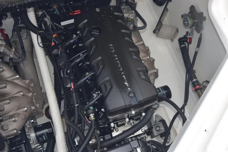 Slide: The Image of Engine compartment of a 2018 Yamaha Boats 212X, showcasing intricate wiring and components. - 21