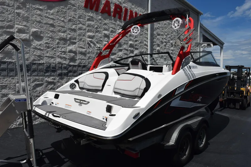 Slide: The Image of 2018 Yamaha Boats 212X on trailer, featuring sleek design and vibrant red accents. - 3