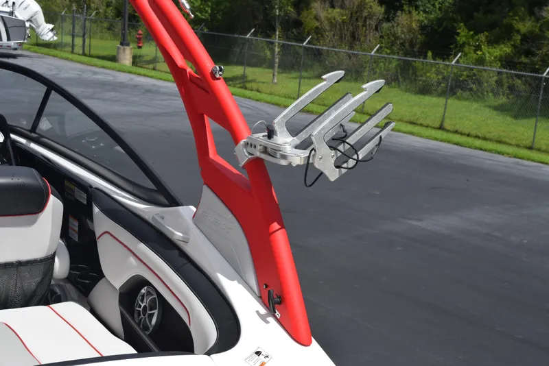 Slide: The Image of 2018 Yamaha Boats 212X interior with red accents and wakeboard rack. - 6