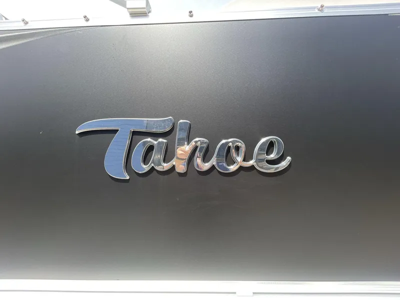 Slide: The Image of 2024 Tahoe Pontoon 25 LSZ QL logo on sleek black surface. - 12