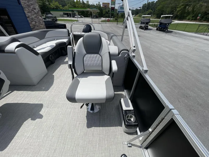 Slide: The Image of 2024 Tahoe Pontoon 25 LSZ QL interior with seating and helm, showcasing modern design. - 18