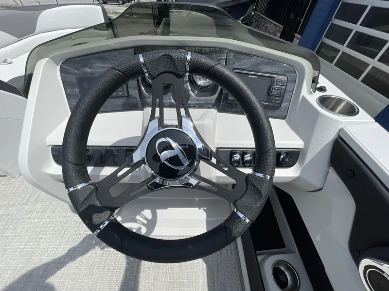 Slide: The Image of 2024 Tahoe Pontoon 25 LSZ QL steering wheel and dashboard with modern controls. - 21