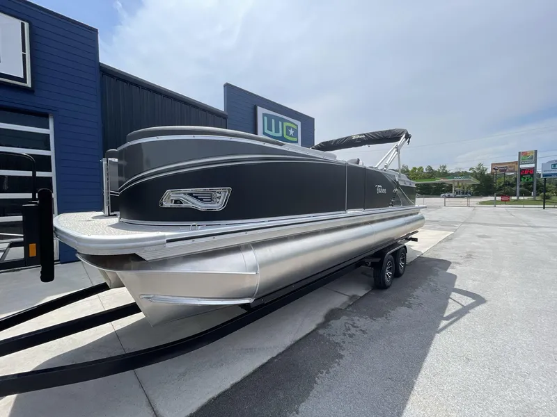 Slide: The Image of 2024 Tahoe Pontoon 25 LSZ QL boat on trailer, parked outdoors. - 3
