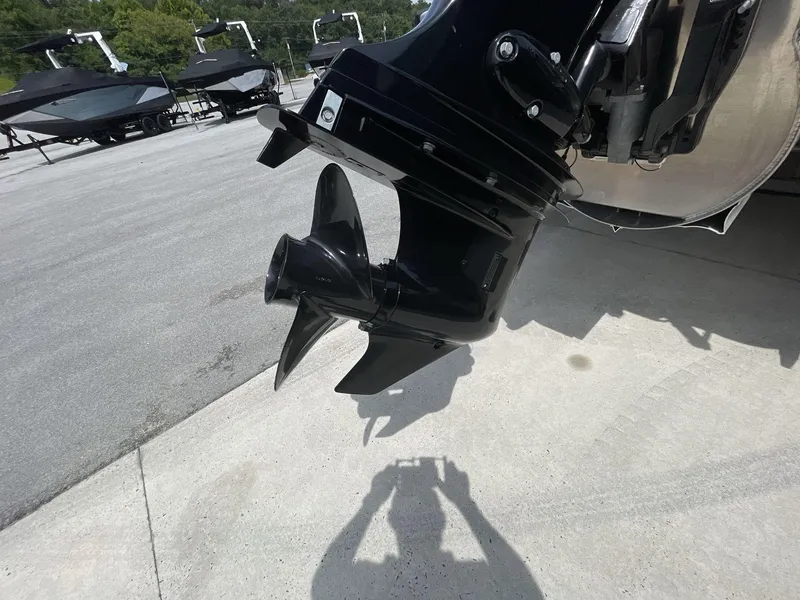 Slide: The Image of Close-up of 2024 Tahoe Pontoon 25 LSZ QL boat propeller on concrete surface. - 8