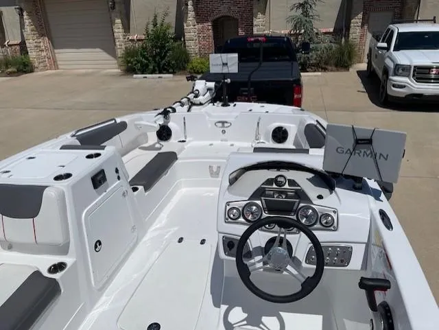 Slide: The Image of 2024 Tahoe 2150 boat interior with steering wheel and Garmin navigation system. - 4