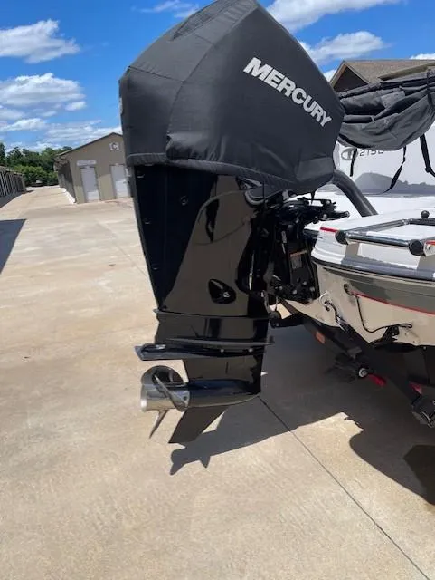 Slide: The Image of 2024 Tahoe 2150 boat with Mercury outboard motor in a sunny outdoor setting. - 6