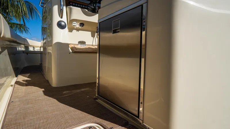 Slide: The Image of 2025 Chris-Craft Catalina 30 interior with stainless steel cabinet and beige flooring. - 18