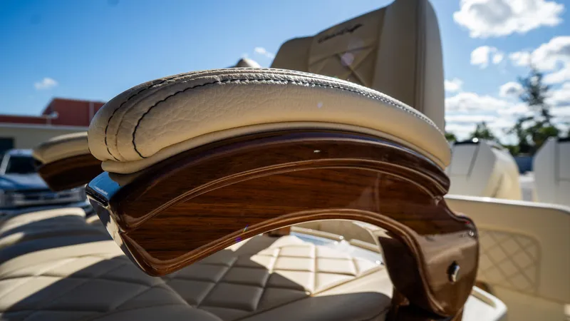 Slide: The Image of Luxurious seating detail on 2025 Chris-Craft Catalina 30 boat, featuring elegant wood and leather design. - 23